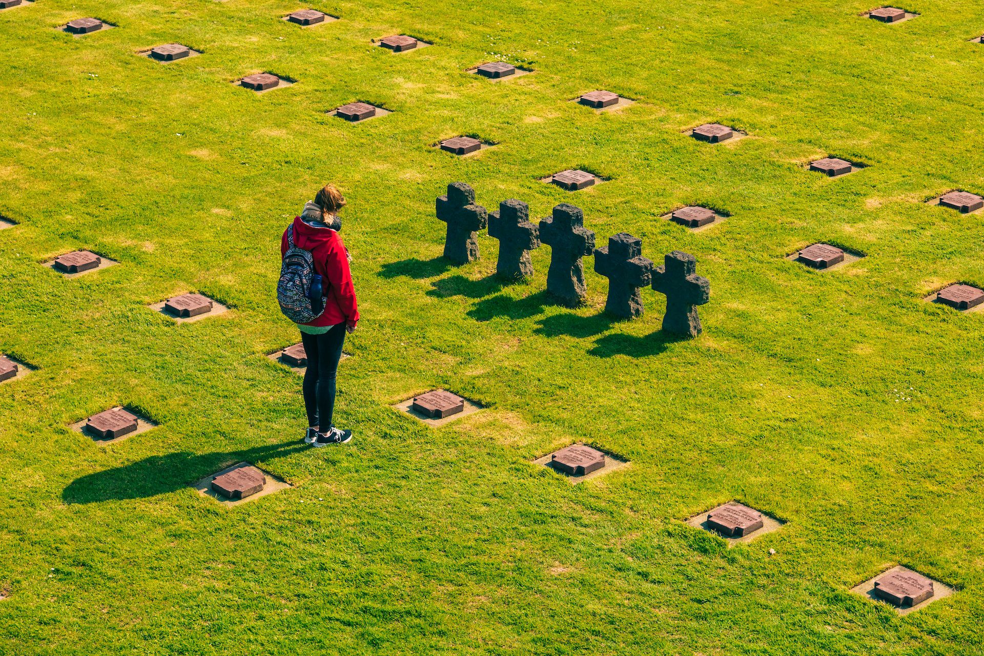 A person standing infront of the cemetery